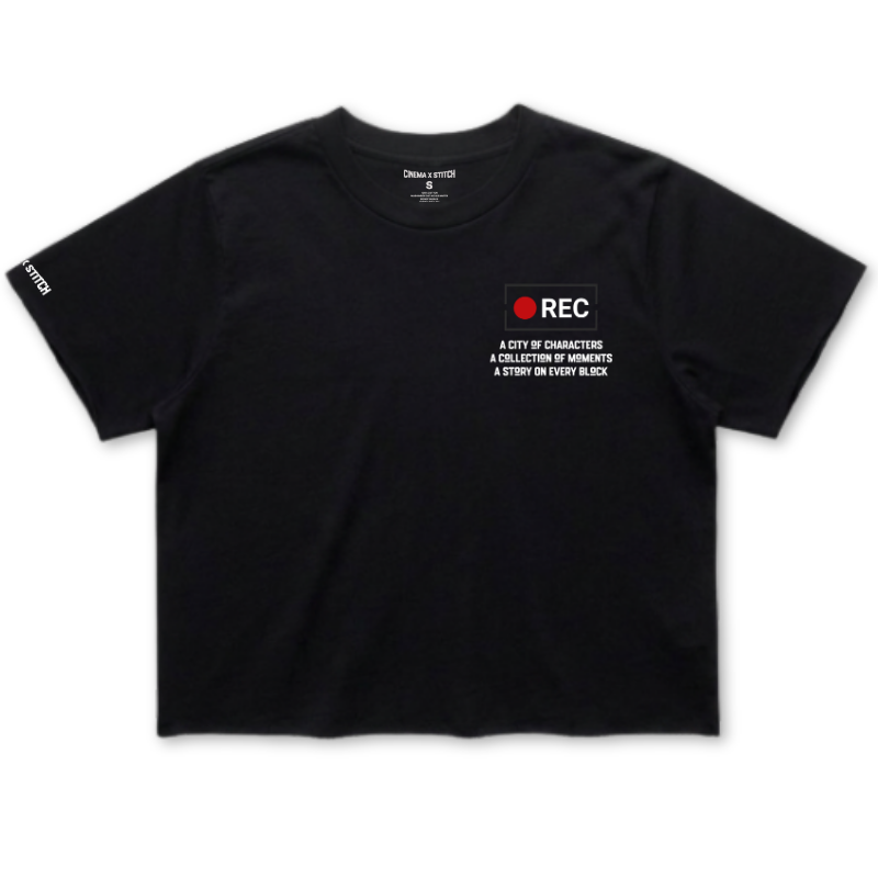 A black short-sleeve t-shirt with a white and red graphic on the left chest reading 'REC' and 'A CITY OF CHARACTER A COLLECTION OF MEMORIES & START ON EVERY BLOCK'. The brand 'Dress of O' is visible printed inside the collar.