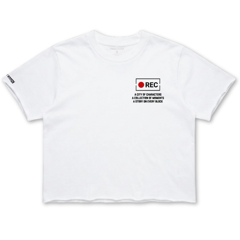 A white short-sleeve crop top t-shirt with a small black and red graphic on the left chest reading 'REC A CITY OF GUNNERS A COLLECTION OF MEMORIES A STORY BY EVERY WEEK'. The brand 'STUDY' is printed in black on the right sleeve.