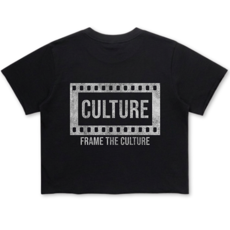 A black short-sleeve crop top t-shirt featuring a distressed white graphic on the front with a film strip border, the word 'CULTURE' in bold, and the phrase 'FRAME THE CULTURE' underneath.