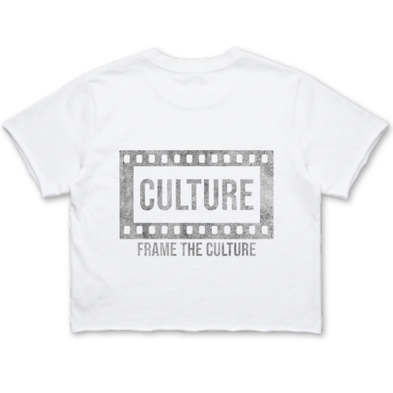 A white short-sleeve crop top t-shirt featuring a distressed gray graphic print on the front. The graphic shows a film strip border enclosing the word 'CULTURE' in bold, with the phrase 'FRAME THE CULTURE' printed underneath.