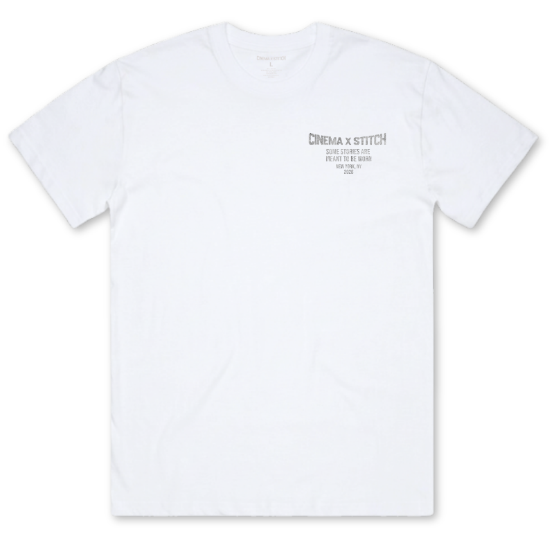 A white short-sleeve crewneck t-shirt with a small gray graphic print on the left chest reading 'CINEMA x STITCH'.